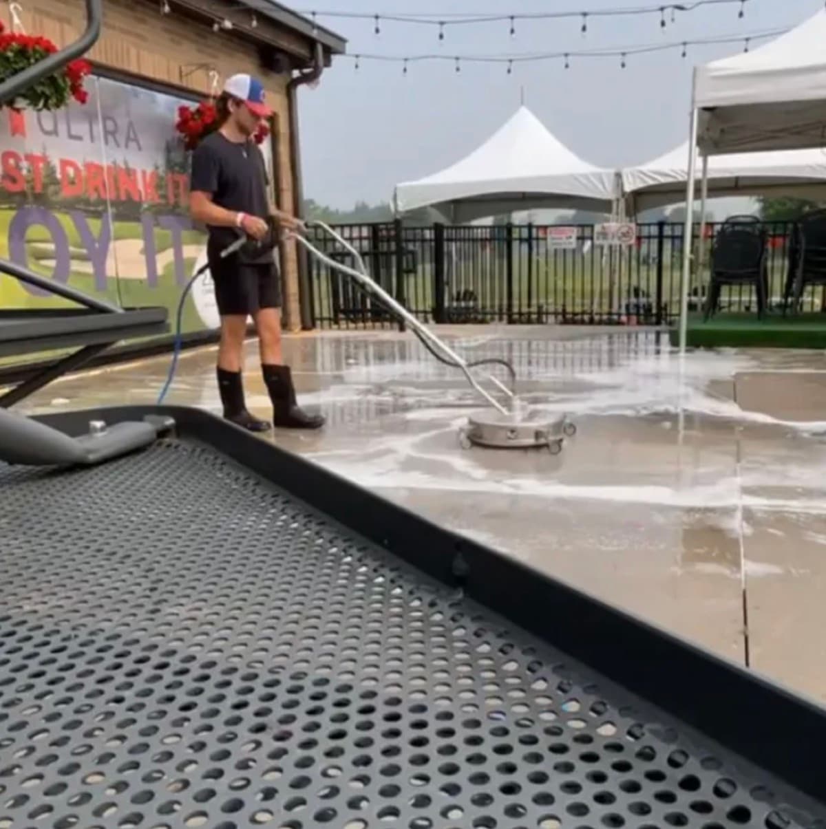 Angelo surface cleaning a restaurant patio with a rotary cleaner