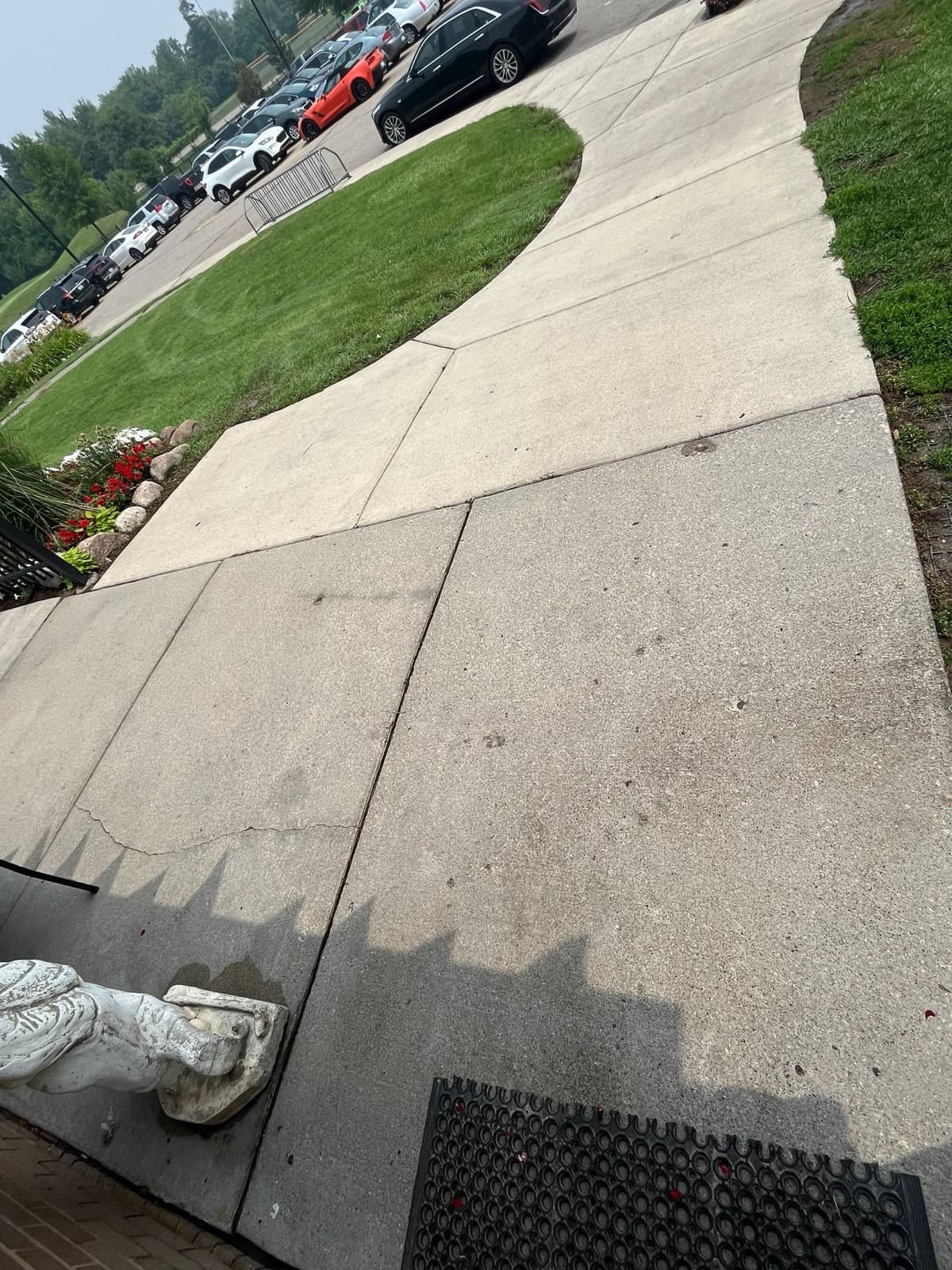 Same concrete sidewalk clean and bright after pressure washing