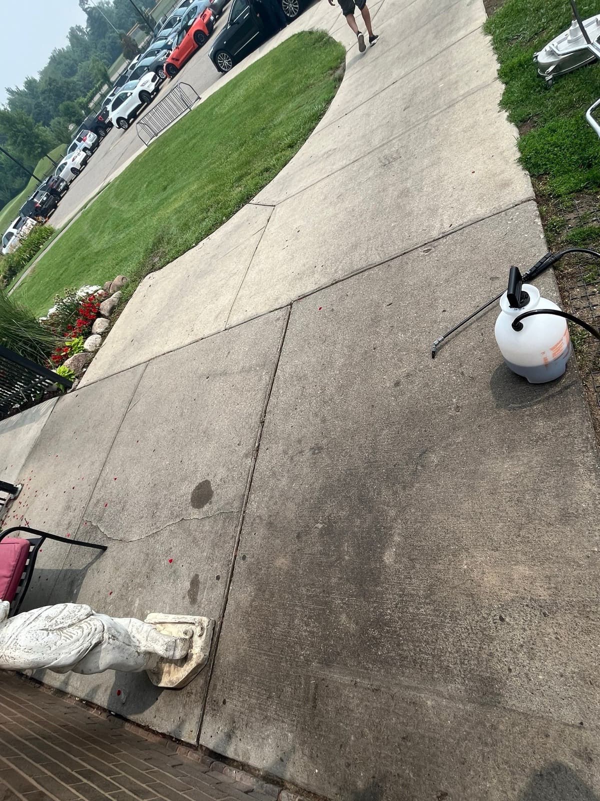 Concrete sidewalk darkened with dirt before pressure washing